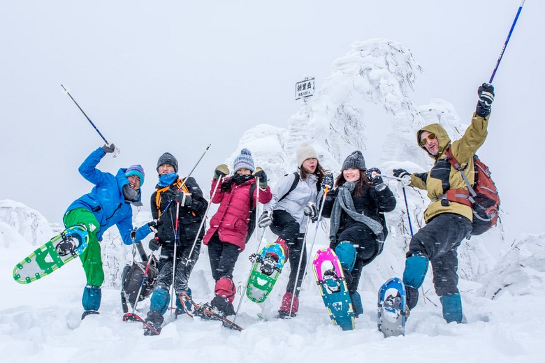 Du khách mặc đồ trượt tuyết nhiều lớp đầy đủ giữa trời tuyết Hokkaido